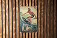 a picture of a man riding a wave on a surfboard