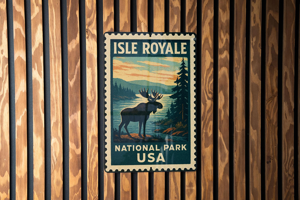 A vintage-style metal sign for Isle Royale National Park in the United States, featuring a moose silhouette against a scenic landscape.