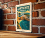 A vintage-style poster of Zakynthos, Greece, displayed on a brick wall.