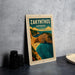 A framed poster of Zakynthos, Greece, featuring a scenic coastal landscape with cliffs, a beach, and turquoise waters.