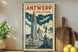 A vintage-style metal sign with a cityscape and a clock tower, featuring the text "ANTWERP BELGIUM" prominently displayed.