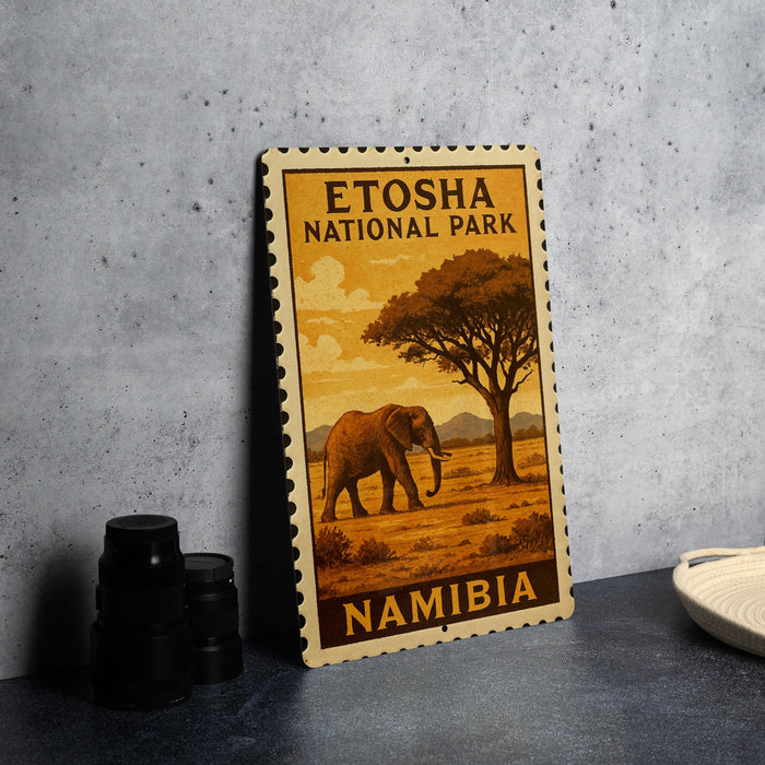 A metal sign with an illustration of an elephant in Namibia, featuring a tree and a sky background.