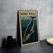 a framed illustration of a Minke whale on a wall, with a stack of black camera lenses and a white dish placed next to it.