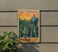 A vintage-style postage stamp depicting a mountainous landscape with the text "TSINGY DE BEMARAH" and "MADAGASCAR" printed on it, hanging on a wall next to a plant.