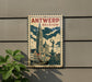 A vintage-style metal sign with the text "ANTWERP BELGIUM" and an illustration of a cityscape with a tall clock tower.