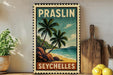 A vintage-style poster of Praslin, Seychelles, featuring palm trees and a beach scene, is displayed on a wall next to a wooden cutting board and a potted plant.