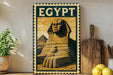 a framed illustration of the Sphinx, a famous ancient Egyptian monument, displayed on a shelf.