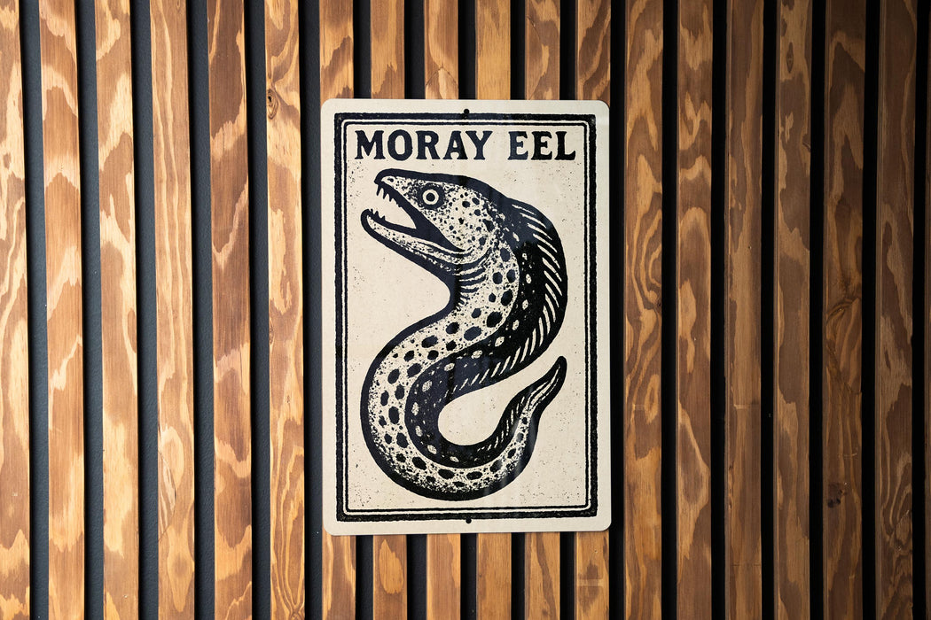 a sign with a fish illustration and the text "Moray Eel" on it, mounted on a wooden wall.