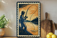 a framed illustration of a man fishing, with a wooden paddle and a wooden cutting board visible in the background.