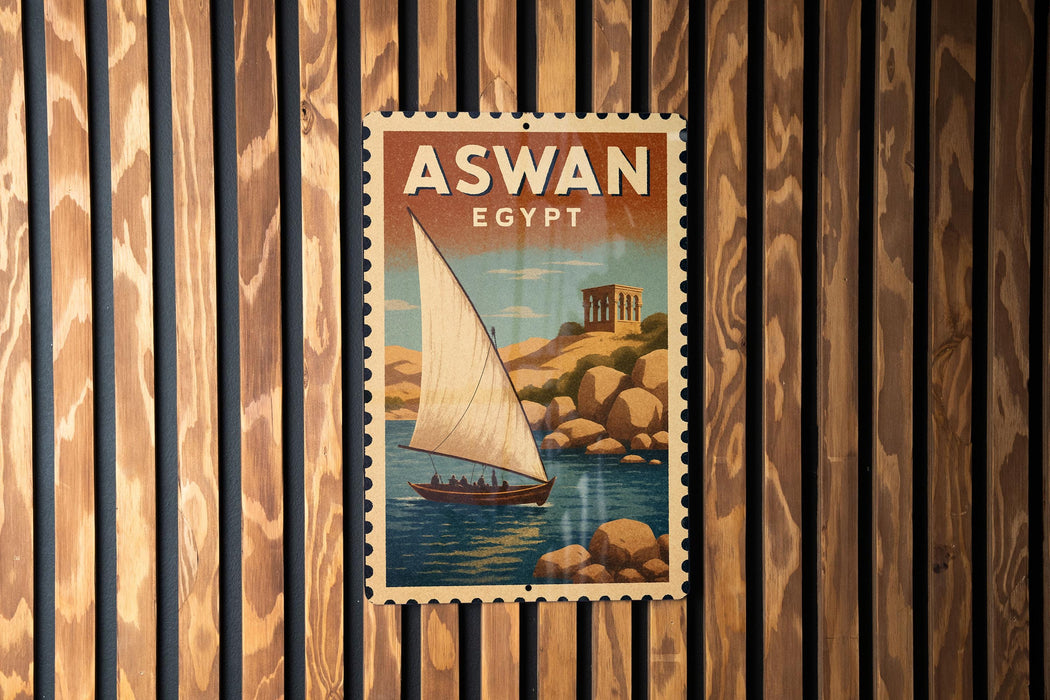A vintage-style poster of a sailboat on a body of water, with the text "ASWAN EGYPT" prominently displayed.