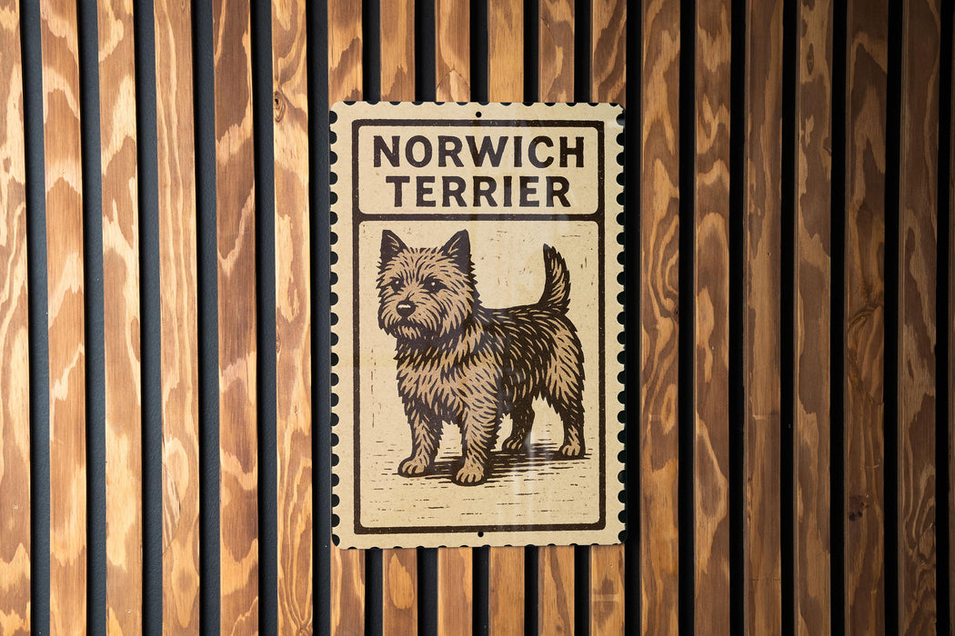A sign for a Norwich Terrier is displayed on a wooden wall.
