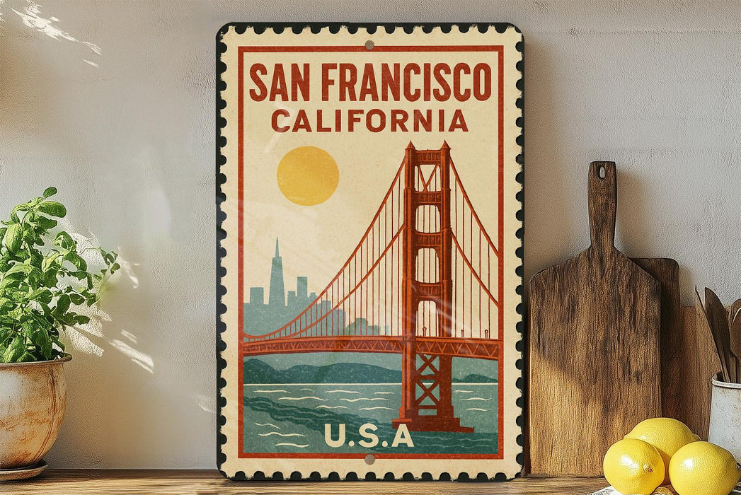 A vintage-style metal sign with the text "SAN FRANCISCO CALIFORNIA" and an illustration of the Golden Gate Bridge, placed on a shelf next to a wooden cutting board and a potted plant.