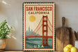 A vintage-style metal sign with the text "SAN FRANCISCO CALIFORNIA" and an illustration of the Golden Gate Bridge, placed on a shelf next to a wooden cutting board and a potted plant.