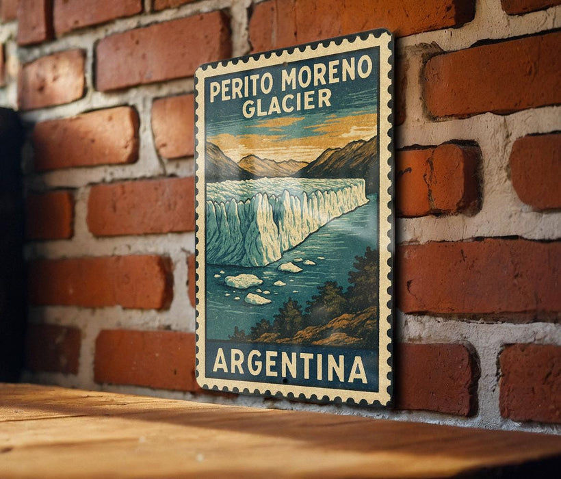 A vintage-style poster of Perito Moreno Glacier in Argentina is displayed on a brick wall.