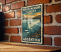 A vintage-style poster of Perito Moreno Glacier in Argentina is displayed on a brick wall.