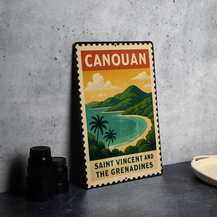 A vintage-style metal sign with a tropical island landscape and text, placed on a gray countertop next to some black camera lenses.