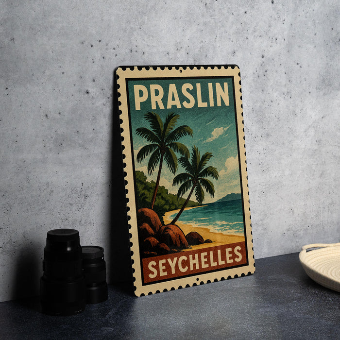 A vintage-style metal sign with a tropical beach scene and palm trees, featuring the text "PRASLIN SEYCHELLES" on the sign.