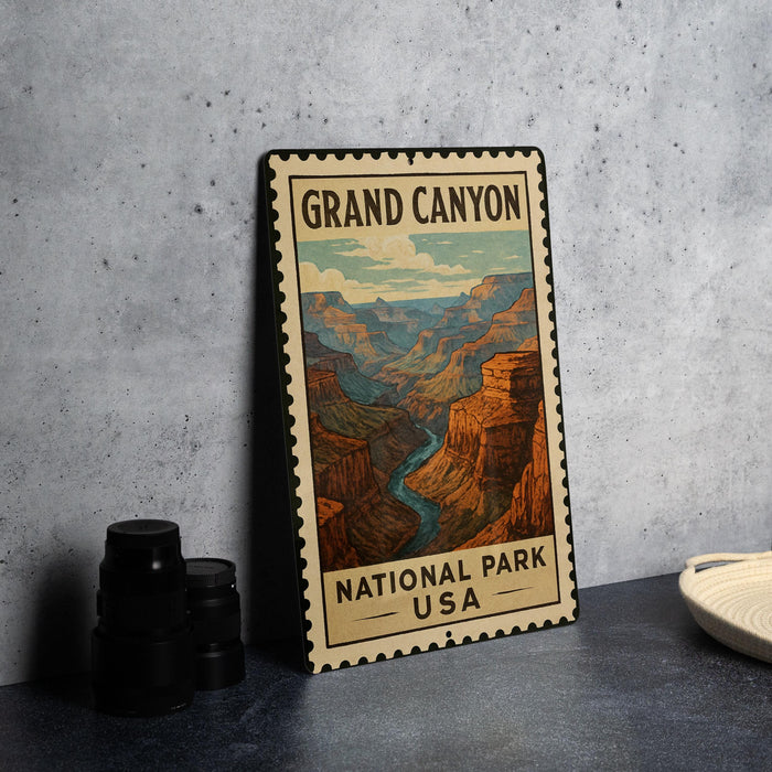 A vintage-style metal sign depicting the Grand Canyon, with the text "GRAND CANYON NATIONAL PARK USA" printed on it.