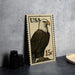 A framed image of a bald eagle on a U.S. postage stamp is displayed on a table.