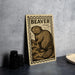 A wooden postcard featuring a beaver illustration is displayed on a table.