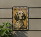 a dog, specifically an English Setter, depicted in a stamp-like design on a wall.