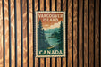 A vintage-style metal sign with the text "VANCOUVER ISLAND CANADA" is displayed on a wooden wall.