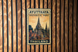A vintage-style postage stamp from Ayutthaya Historical Park in Thailand, featuring an illustration of a temple and the text "Ayutthaya Historical Park" and "Thailand".