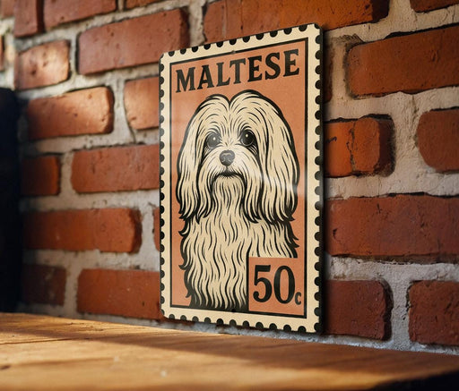 A framed illustration of a Maltese dog, with the text "MALTESE" and "50c" printed on it, is displayed on a brick wall.