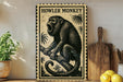 A framed illustration of a howler monkey is displayed on a shelf, accompanied by a wooden cutting board and a potted plant.