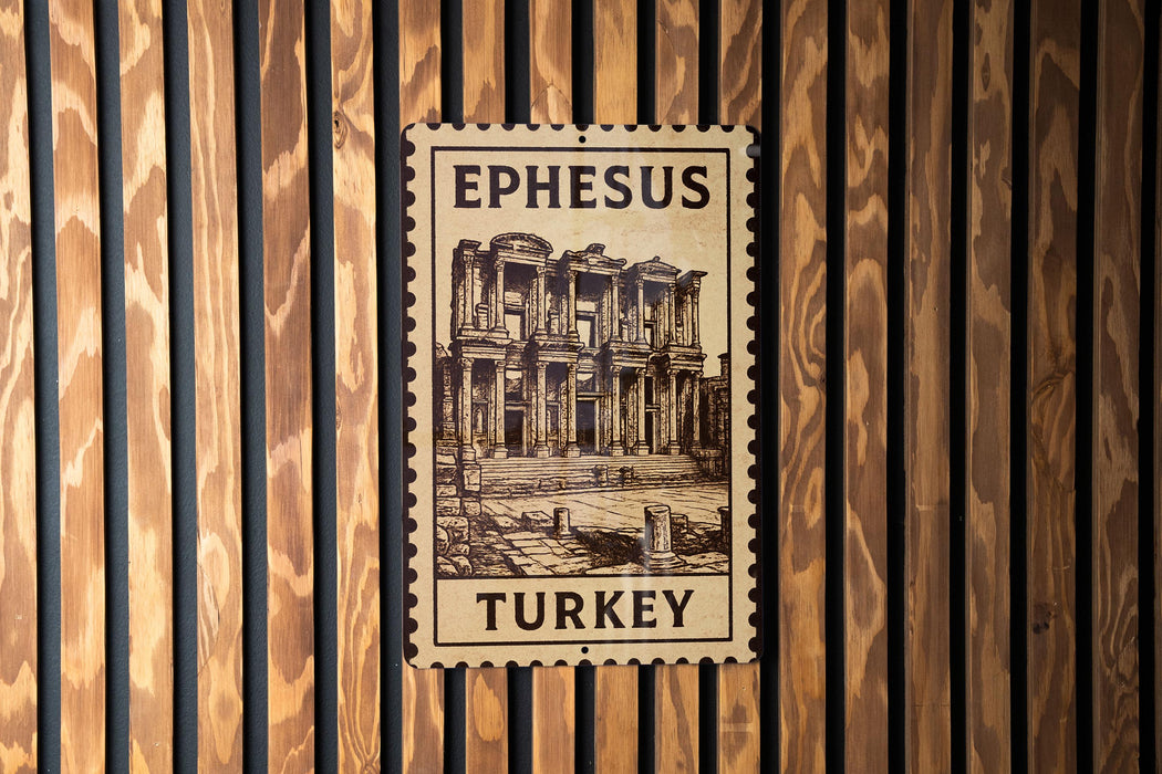 A wooden wall with a framed image of the ancient city of Ephesus, Turkey, mounted on it.