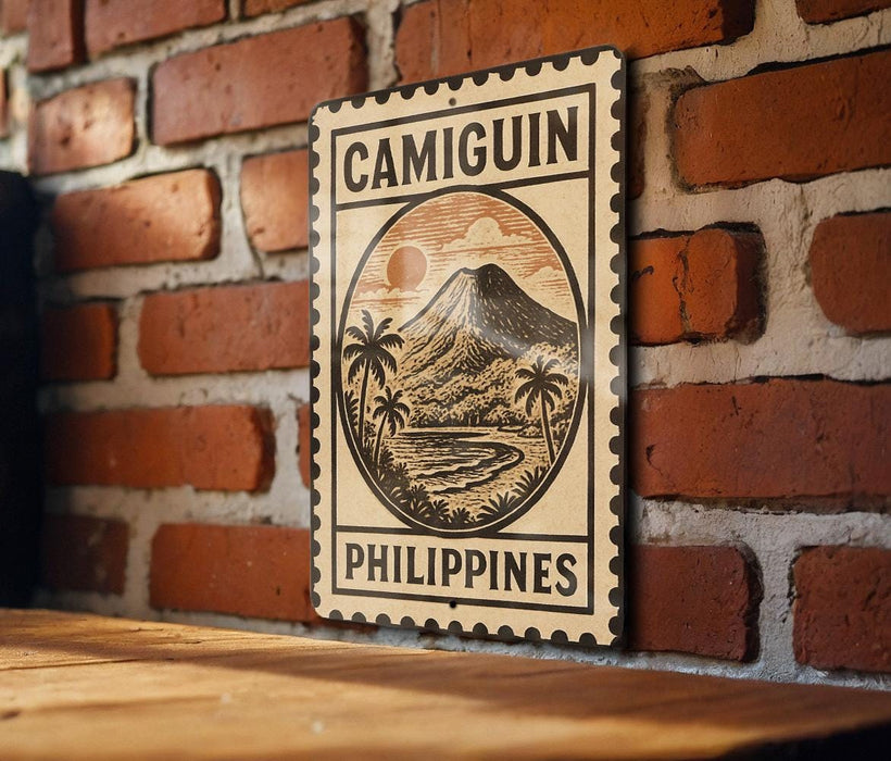 a sign with the word "CAMIGUIN" and "PHILIPPINES" printed on it, mounted on a brick wall.