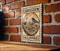 a sign with the word "CAMIGUIN" and "PHILIPPINES" printed on it, mounted on a brick wall.
