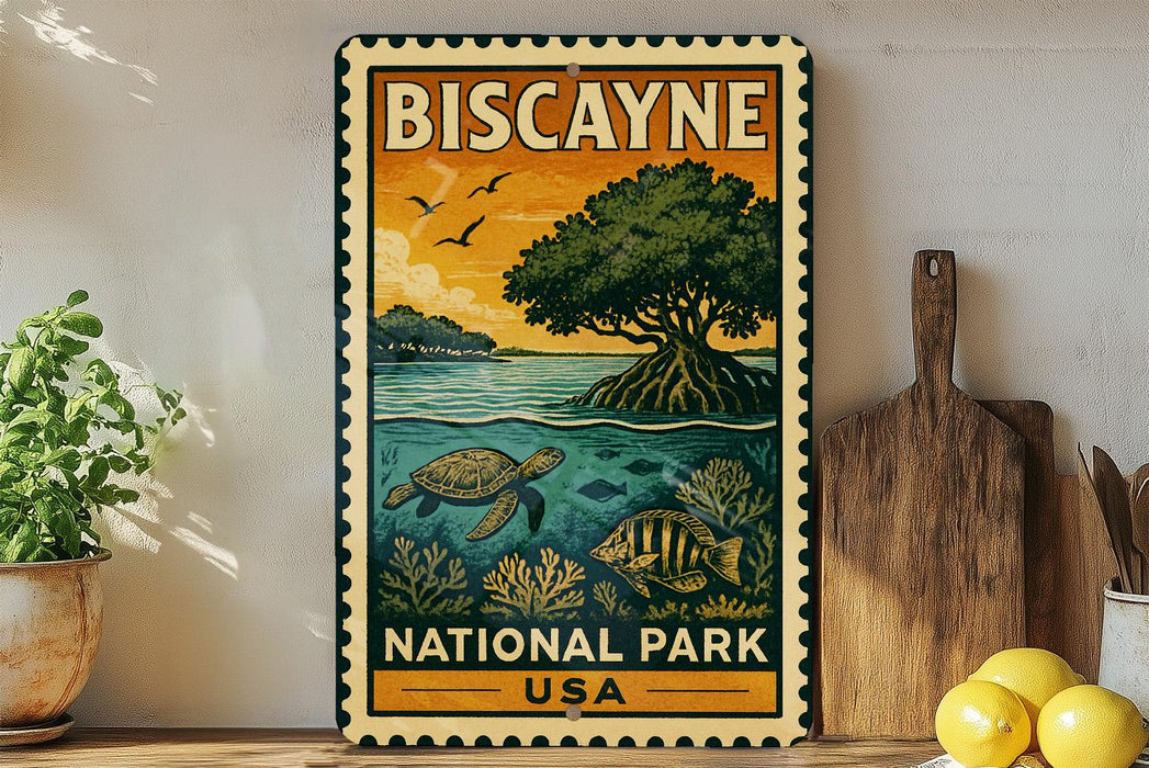 A vintage-style metal sign for Biscayne National Park, featuring illustrations of a tropical island, sea turtle, and fish, is displayed on a shelf next to a wooden cutting board and a potted plant.