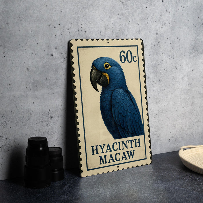 A metal stamp featuring a blue parrot, with the text "HYACINTH MACAW" printed on it.