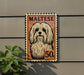 a Maltese dog, which is a breed of small, long-haired, and curly-haired dog. The dog is depicted in a stamp-like design, with the word "MALTESE" written above it. The dog is also shown with a price tag of 50 cents.