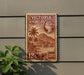 A vintage Victoria Seychelles postage stamp is displayed on a wall, featuring a tropical landscape with palm trees and mountains.