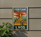 A vintage-style sign with a temple illustration and the word "Vientiane" written on it, mounted on a wall.