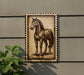 a framed illustration of a horse on a wall.