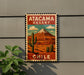 A vintage-style metal sign with a desert landscape and a cactus, mounted on a wall.