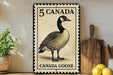 A metal sign with a black and white illustration of a Canada goose, along with the text "5 CANADA" and "CANADA GOOSE".