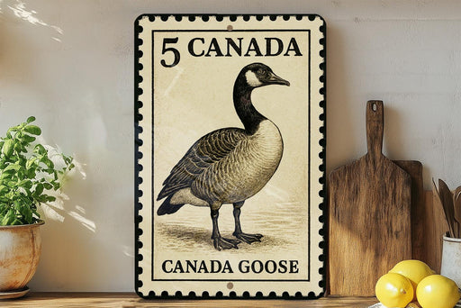 A metal sign with a black and white illustration of a Canada goose, along with the text "5 CANADA" and "CANADA GOOSE".