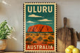 A vintage-style metal sign with the text "ULURU AUSTRALIA" and an illustration of Uluru, a famous rock formation in Australia.