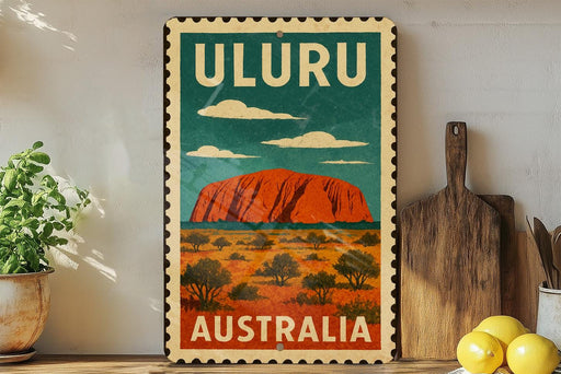 A vintage-style metal sign with the text "ULURU AUSTRALIA" and an illustration of Uluru, a famous rock formation in Australia.