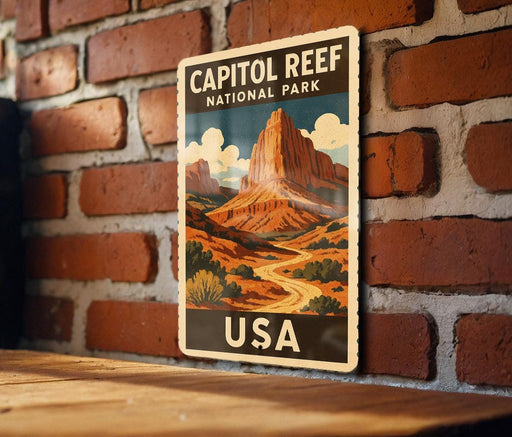 A vintage-style poster of Capitol Reef National Park in the USA, featuring a mountain landscape with a winding road and desert vegetation.