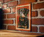 a framed illustration of a dog, specifically a Rottweiler, mounted on a brick wall.