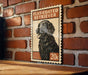 A vintage-style stamp featuring a black flat-coated retriever dog, with the text "FLAT-COATED RETRIEVER" and a price of "20c".