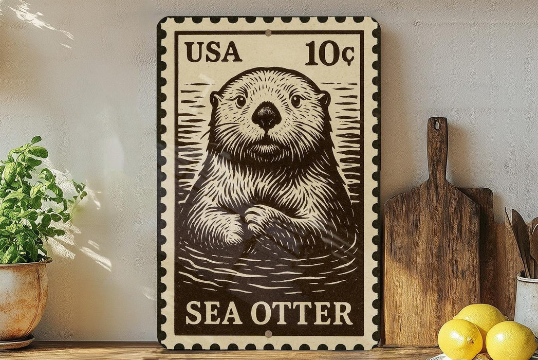 A metal stamp featuring a sea otter, with the text "USA 10¢" printed on it. The stamp is placed on a wooden surface, with a potted plant, a wooden cutting board, and some lemons nearby.
