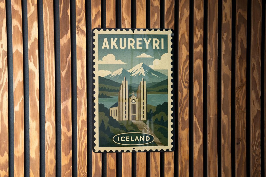 A vintage-style poster of Akureyri, the capital city of Iceland, is displayed on a wooden wall.