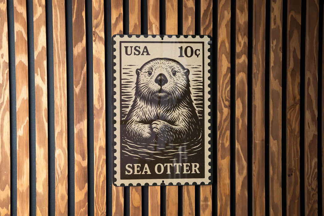 A black and white postage stamp featuring an illustration of a sea otter.
