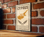 a sign with the word "CYPRUS" on it, mounted on a brick wall.